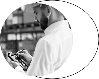 Man in warehouse typing into a handheld scanner