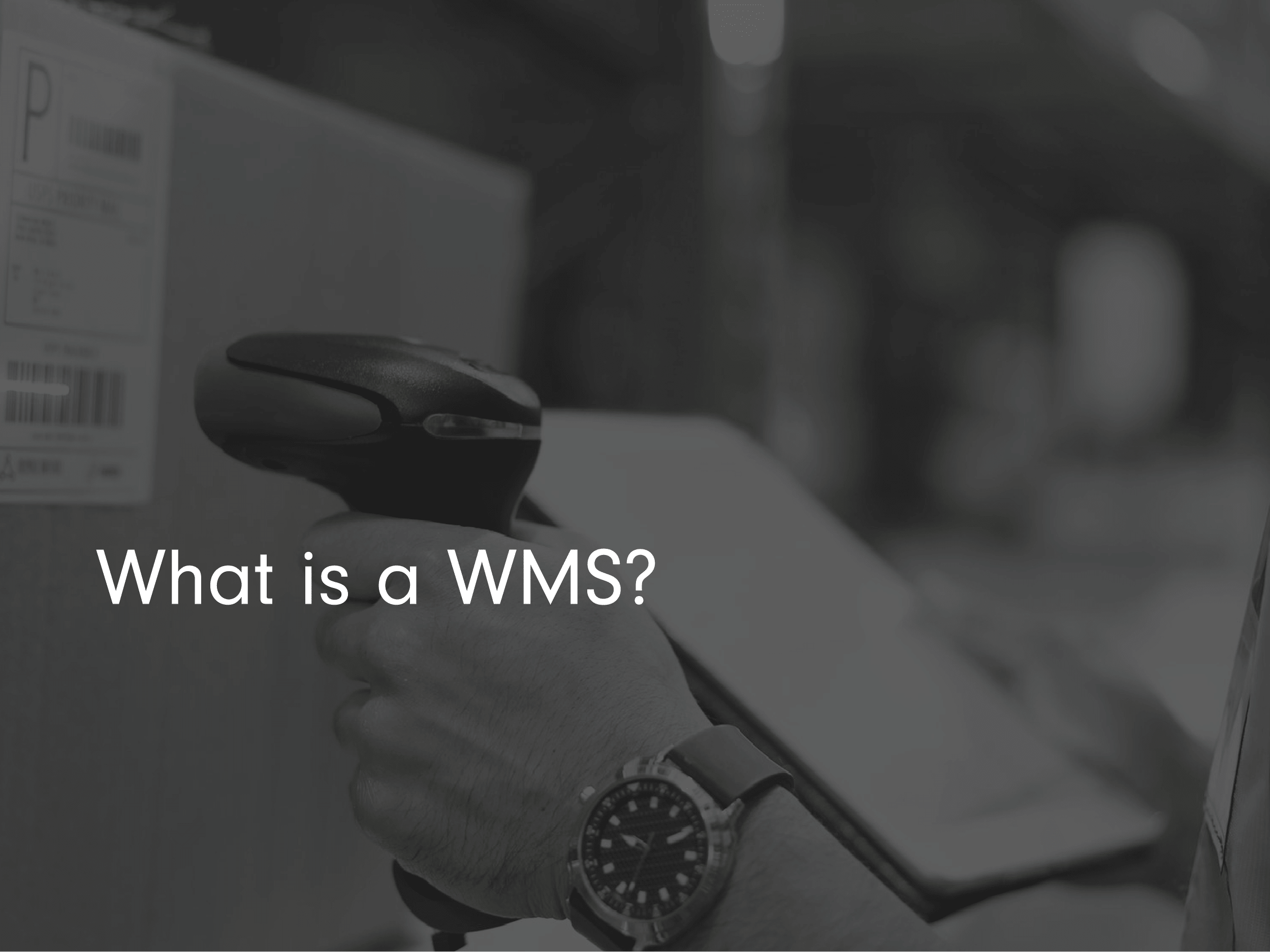 Blog Post Title Page: What is a WMS? with black and white warehouse imagery