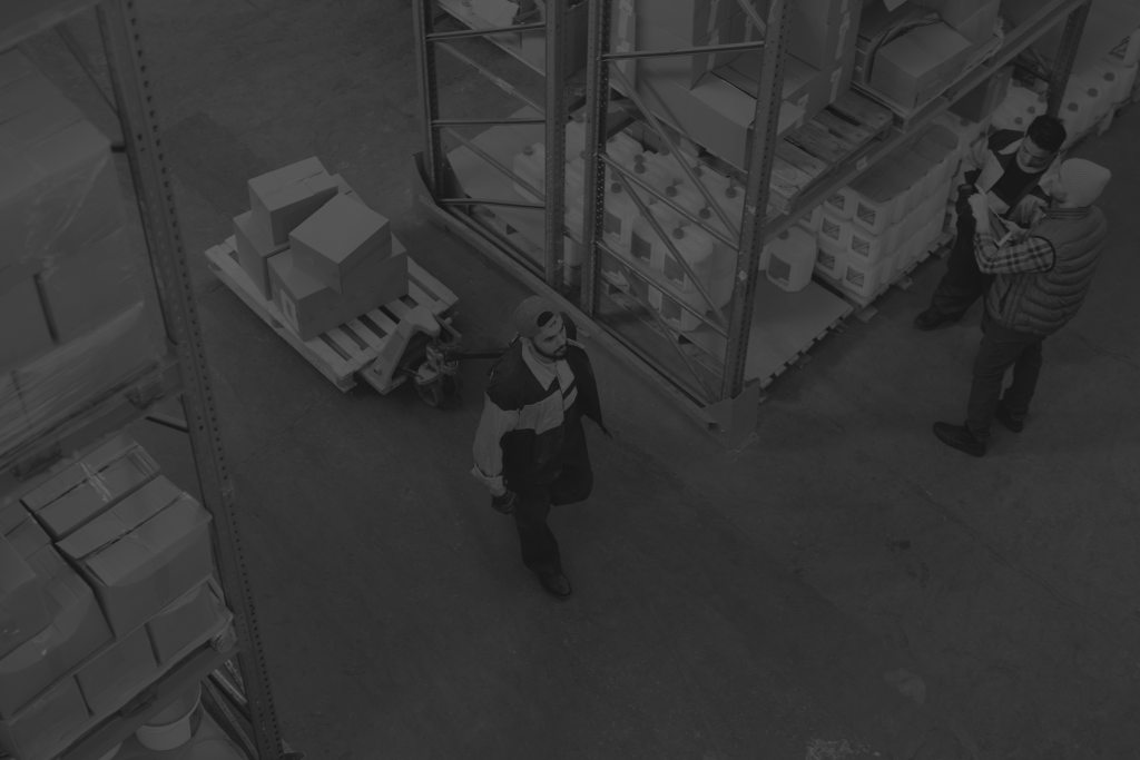 man moving boxes through a warehouse