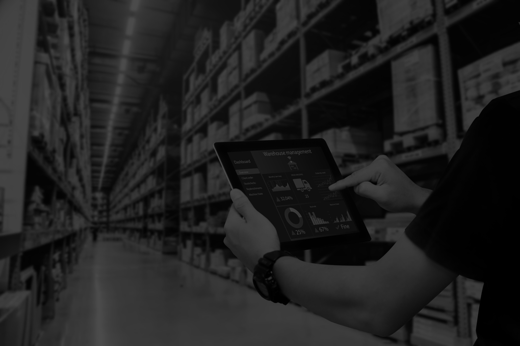 Smart warehouse management system.Worker hands holding tablet on blurred warehouse as background