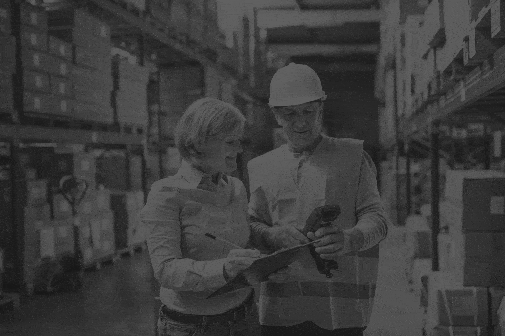 senior-woman-manager-and-man-worker-working-in-a-warehouse.