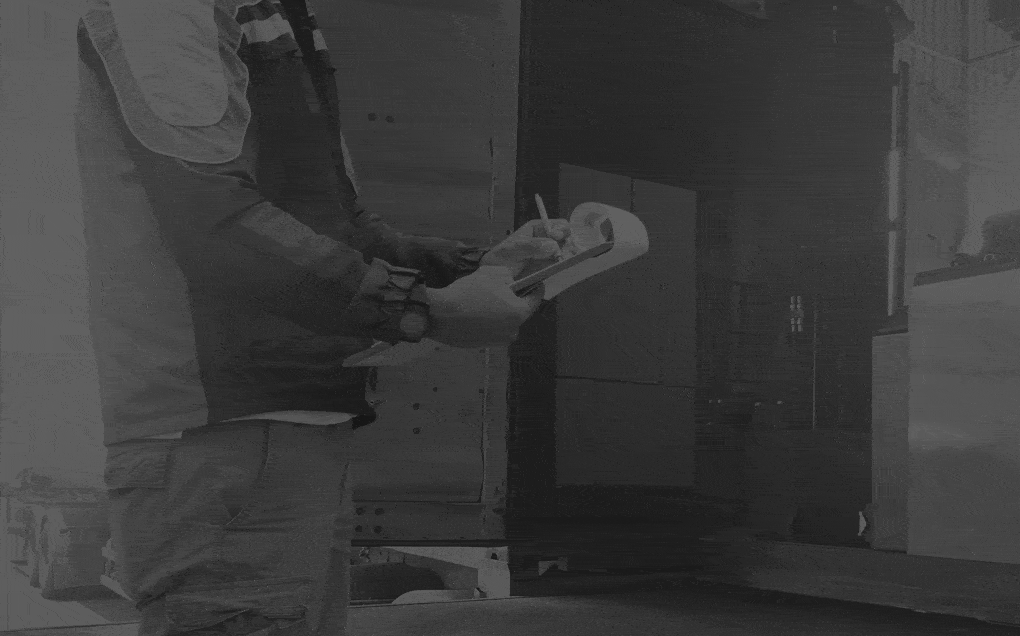 Worker-Holds-a-Clipboard-Checking-the-Loading-Cargo-Shipment-at-Distribution-Warehouse