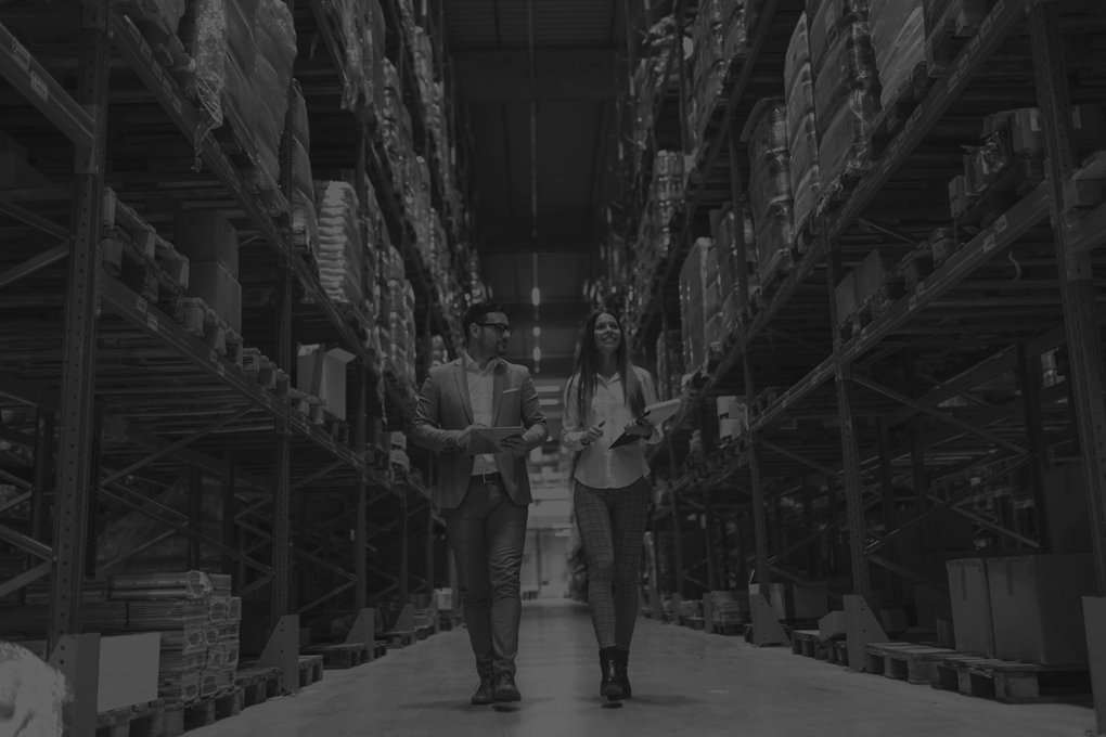warehouse-managers-walking-through-large-distribution-center