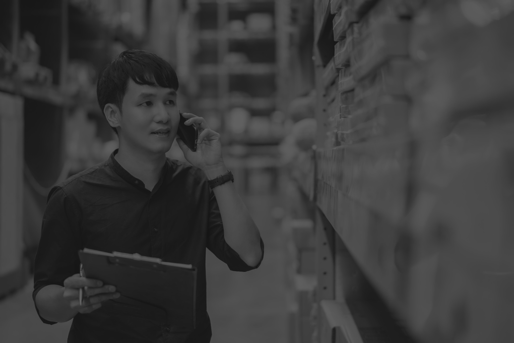 young-man-worker-talking-mobile-phone-holding-clipboard-check-inventory-warehouse-store