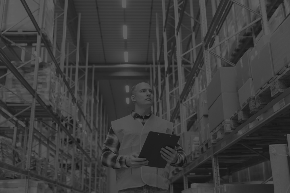 warehouse-worker-with-clipboard-safety-vest