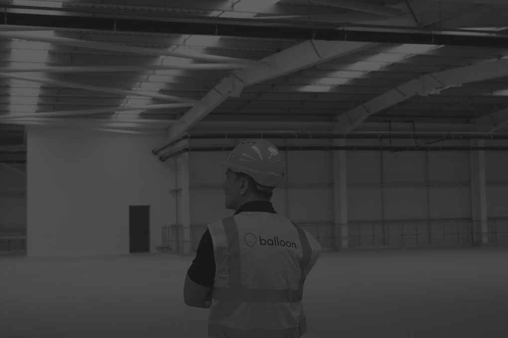 Balloon employee in empty warehouse