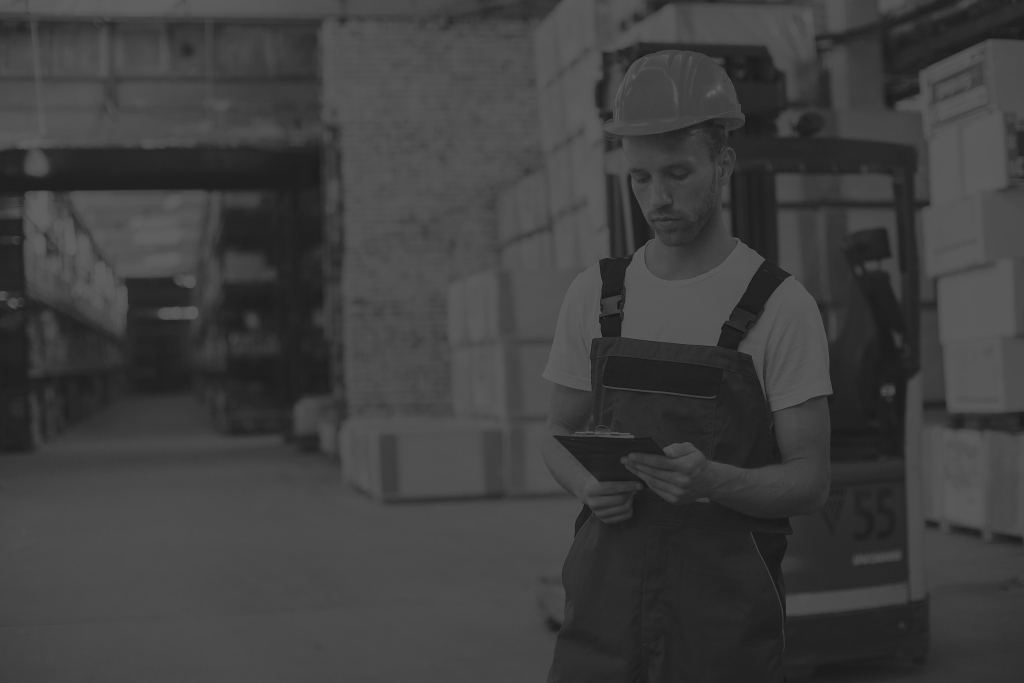 industrial worker indoors factory young technician with orange hard hat black and white