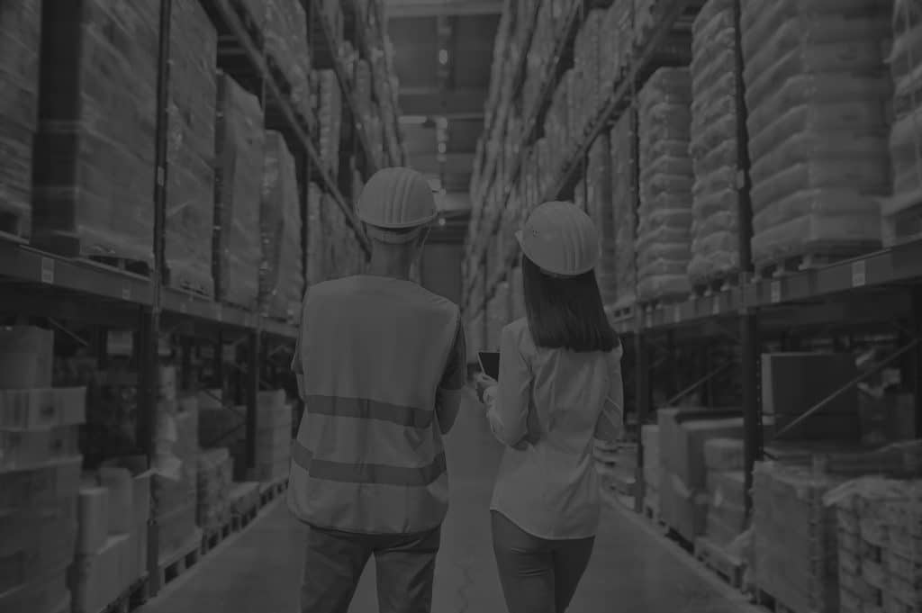 back-view-woman-man-warehouse-aisle-space-utilisation-black-and-white