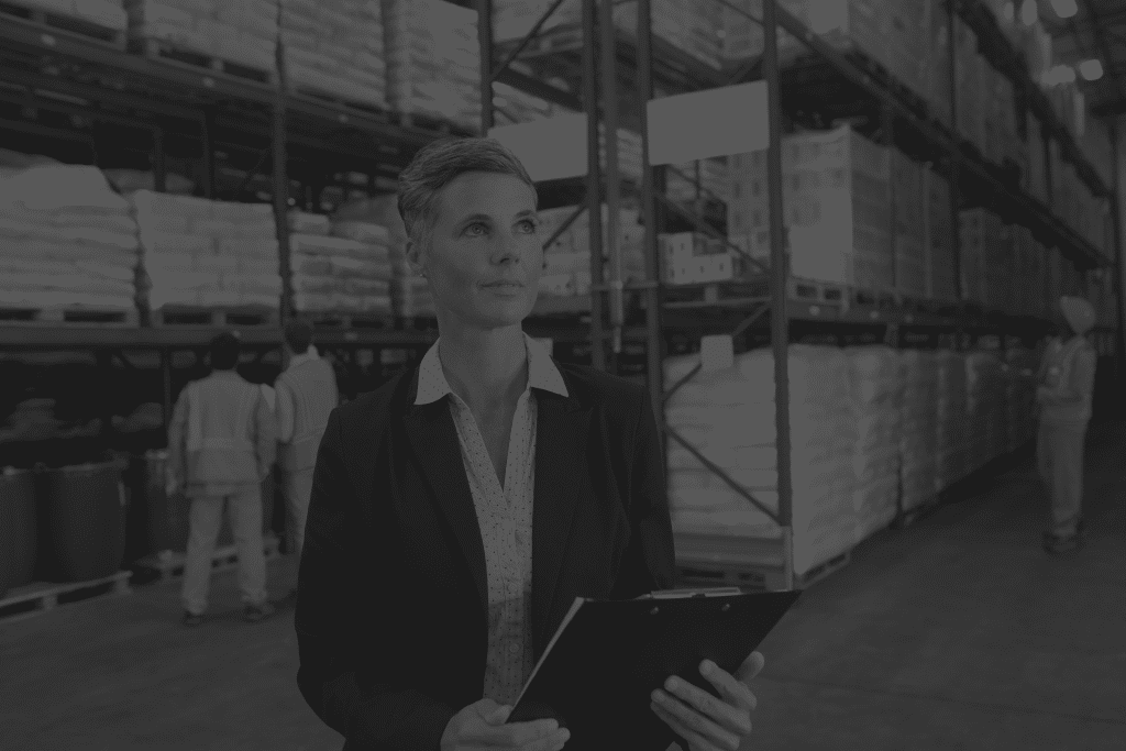 female-manager-checking-stocks-clipboard-warehouse