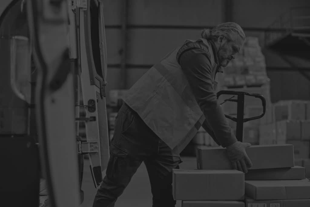 mature-worker-loading-cardboard-containers-truck-his-work-warehouse-otif-black-and-white