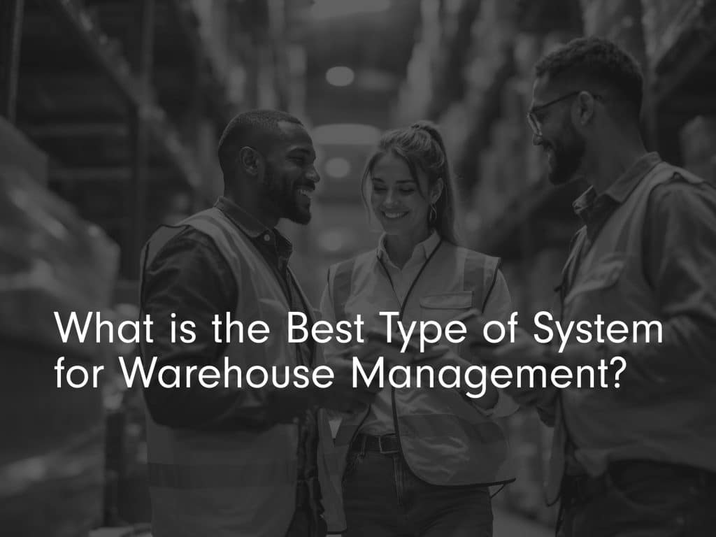 'what is the best type of system for warehouse management?' title image in black and white with 3 smiling warehouse workers in hi vis jackets holding scanners