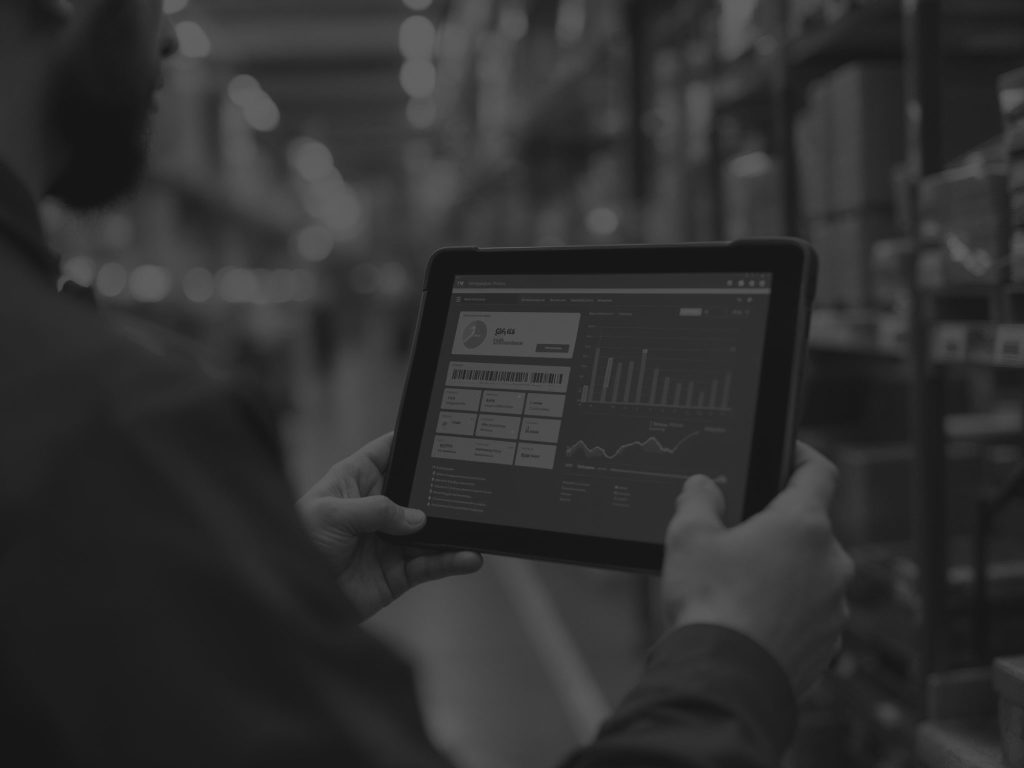 close upof tablet with warehouse metrics on it being held by man's hand