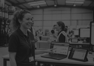 WMS Implementation gone well woman happy in front of dashboard black and white